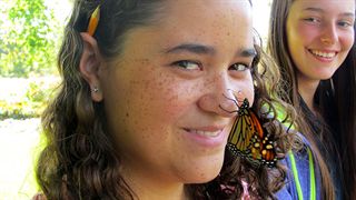 Hamilton District student with Monarch butterfly on her nose