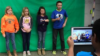 Lansing Christian students using a green screen